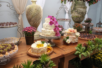 Wedding Setup. Cake table with sweet, decoration and flowers