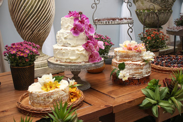 Obraz na płótnie Canvas Wedding Setup. Cake table with sweet, decoration and flowers