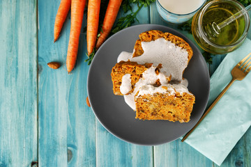 Top view of vegan carrot cake pieces on aqua-menthe wooden background