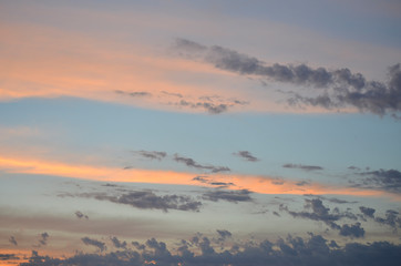 Pastel Blue Sky Background with Orange and Purple Clouds