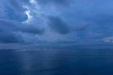 Beautiful blue sunset on the ocean with big waves and cliffs and cliffs. Bali island with its tropical and exotic nature. Sunrise over the sea and ocean. Phantom blue in sunset