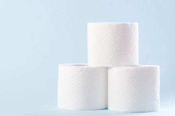 White toilet paper rolls on the gray background. Hygiene concept.