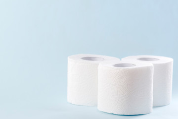 White toilet paper rolls on the gray background. Hygiene concept.