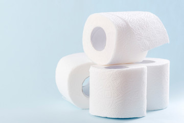 White toilet paper rolls on the gray background. Hygiene concept.