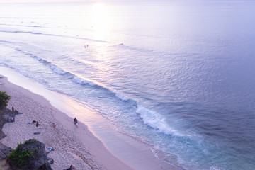 Waves and clouds. Blue ocean Beautiful sunset at Balangan Beach on the island of Bali in Indonesia. Surfers catch the waves, tourists relax and enjoy the sunset or sunrise