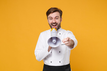 Excited young bearded male chef cook or baker man in white uniform shirt isolated on yellow...