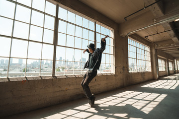 Fototapeta na wymiar Man dancing in industrial warehouse
