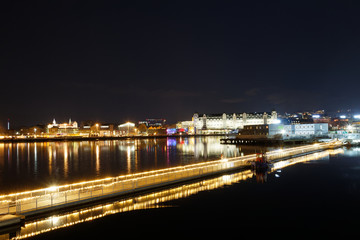 Dark night sky view on Oslo city from Sørenga neighborhood with bridge over fjord decorated with lighted garland on background, Sorenga, long exposure photography, Norway, Scandinavia