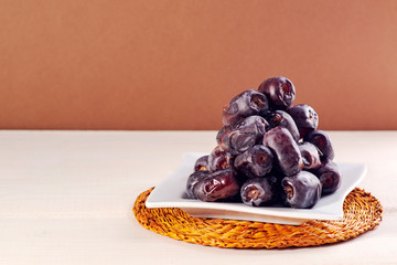 Dates in plate. Dried dates fruits.