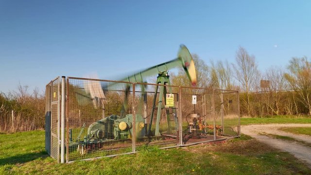 Timelapse of working oil pump from oil field at sunset in Lower Saxony. Germany.