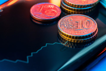 Euro coin on stock chart. Financial investment concept. Close up.