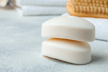 Bar of natural handmade soap, towel and spa objects, close up