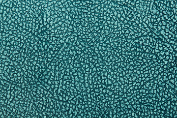 Old bluish faux leather. Leatherette. Close-up. Background. Texture.