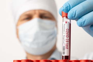 Doctor hols one coronavirus test-tube with negative result after laboratory analysis