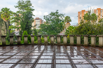 Wet and Huge Balcony with a Square Brick Floor and a Cement Railing