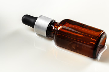 Skincare serum bottle on a light beige background close up