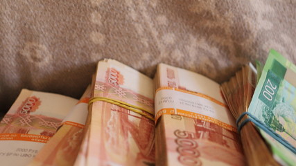 bundles of Russian money, 5000 bills scattered on the floor, recalculate savings for an apartment