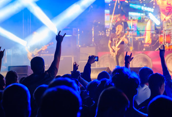 Fototapeta na wymiar Fans listening to rock band on stage