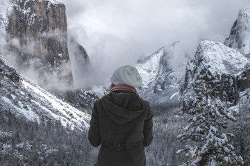 Rear view of hiker standing in snowy Yosemite Valley