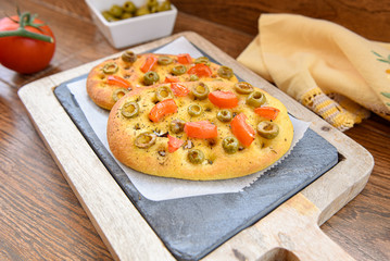 variety of different focaccia, with pumpkin, carrot and beet, on a rustic table