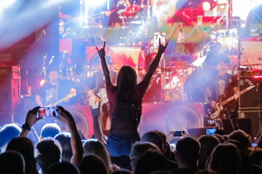 Fans at live rock music concert cheering
