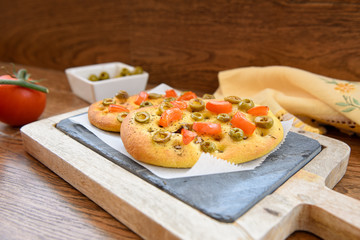 variety of different focaccia, with pumpkin, carrot and beet, on a rustic table