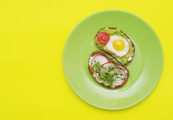  Sandwiches with healthy vegetables, tomatoes, eggs, micro greens on plate on colorful background. Healthy food concept.