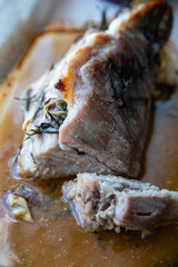 Baked delicious fat pork meat seasoned with salt, papper, garlic and rosemary branches