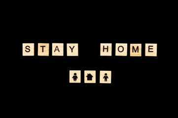 Black background. Stay home concept. Coved-2019 concept. Words. Letters on wooden blocks. 
