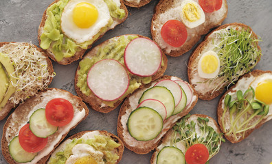 Sandwiches with vegetables, eggs, avokado and micro greens. Healthy food.