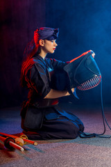 caucasian kendo fighter sit on the floor before fighting, wearing special kendo dress and using all...