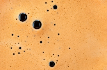 Closeup of espresso foam. Golden foam of natural coffee