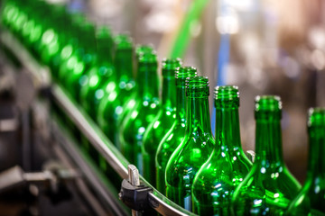 Bottling and conveyor line or belt at winery factory, Wine bottles filling production.