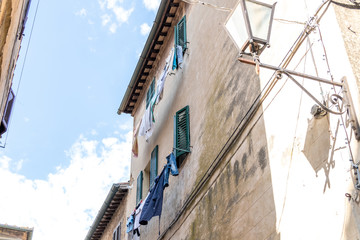 Fototapeta na wymiar linen dried at a window on a street in Italy