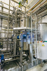 Modern brewing equipment in beer factory, steel vats for fermentation and maturation of beverage