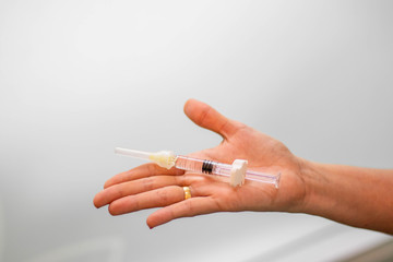 Hand holding a syringe with medicine on clear background. Medicine concept