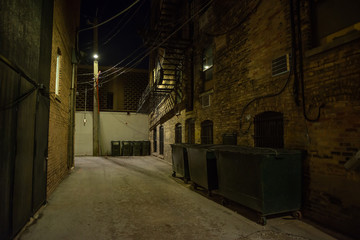 Dark and eerie urban city alley at night 