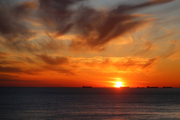 Naklejka na ściany i meble Beautiful photo of a bright sunset on the sea