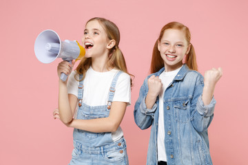 Funny little kids girls 12-13 years old in white t-shirt, denim clothes isolated on pastel pink...