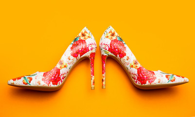 Stylish female shoes in colors. Fashionable women shoes. Colored women shoes on yellow, orange...