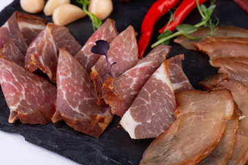 Meat plate of bulk slugged and smoked meat, served with crumbs, garlic and pepper with pickles