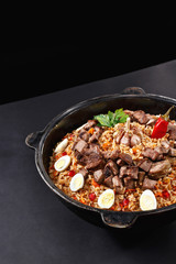 Vertical shot of pilaf. Traditional Uzbek dish plov. Same like biryani in India. Family portion. Best concept for promotion