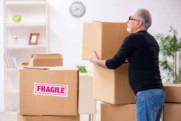 Fototapeta premium Old male professional mover doing home relocation