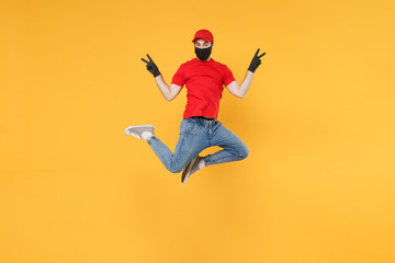 Fototapeta na wymiar Fun jumping delivery man in red cap t-shirt uniform sterile face mask gloves isolated on yellow background studio Guy employee courier Service quarantine pandemic coronavirus virus 2019-ncov concept.