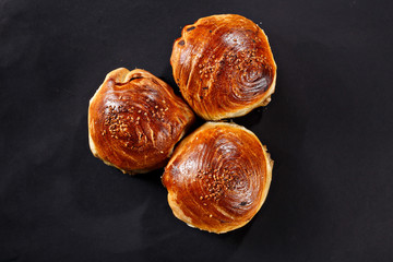 Uzbek bread. National middle asian buns. Black background.