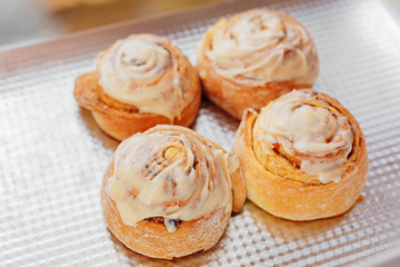 Obraz na płótnie Canvas Stack of freshly cinnabon, French buns with cinnamon and cream