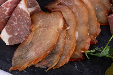 Meat plate of bulk slugged and smoked meat, served with crumbs, garlic and pepper with pickles