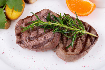 Grilled steak, served with potatoes in mundiers and blackcurrant sauce