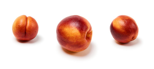 three ripe nectarines on a white background