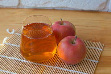 Delicious fresh squeezed apple juice in  transparent glass